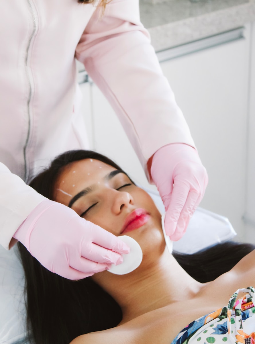 A Woman Getting A Facial Mask On Her Face